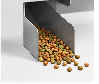 Close-up of the AK Feeder feed chute that delivers each portion