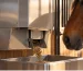 Stainless steel automatic horse feeder dispensing pellets into a trough as a horse looks on
